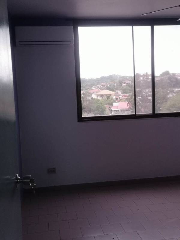 Bedroom with large window, AC unit, tile floors and city views in PH El Dorado Panama