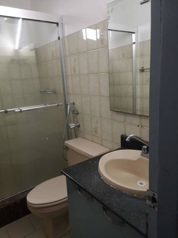 Bathroom with glass shower enclosure, beige fixtures, floral wall tiles PH El Dorado Panama