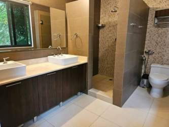 Modern bathroom dual sinks walk-in shower glass enclosure River Valley Panama Pacifico house for sale