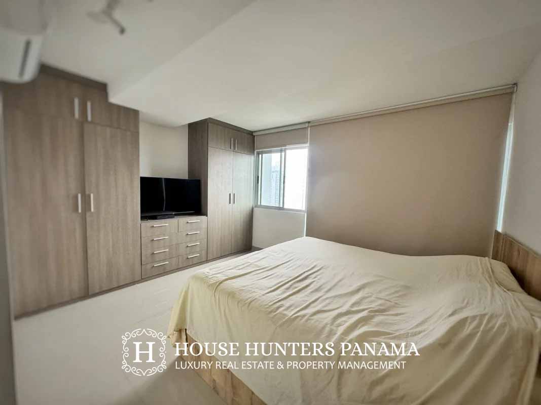 Bedroom with large windows overlooking Panama City skyline at PH Residencias del Sol