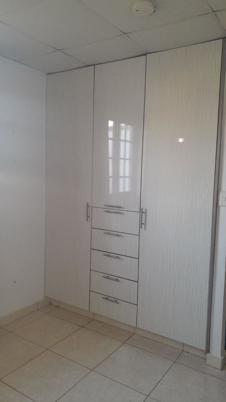 Modern built-in white wardrobe with drawers in bedroom of corner house for sale Los Álamos Pacora Panama