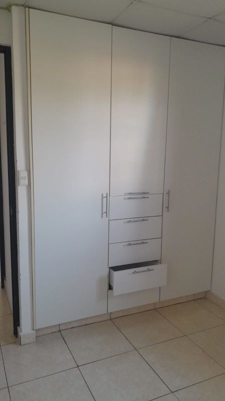 Spacious built-in wardrobe with drawers in tiled bedroom Los Álamos Pacora Panama