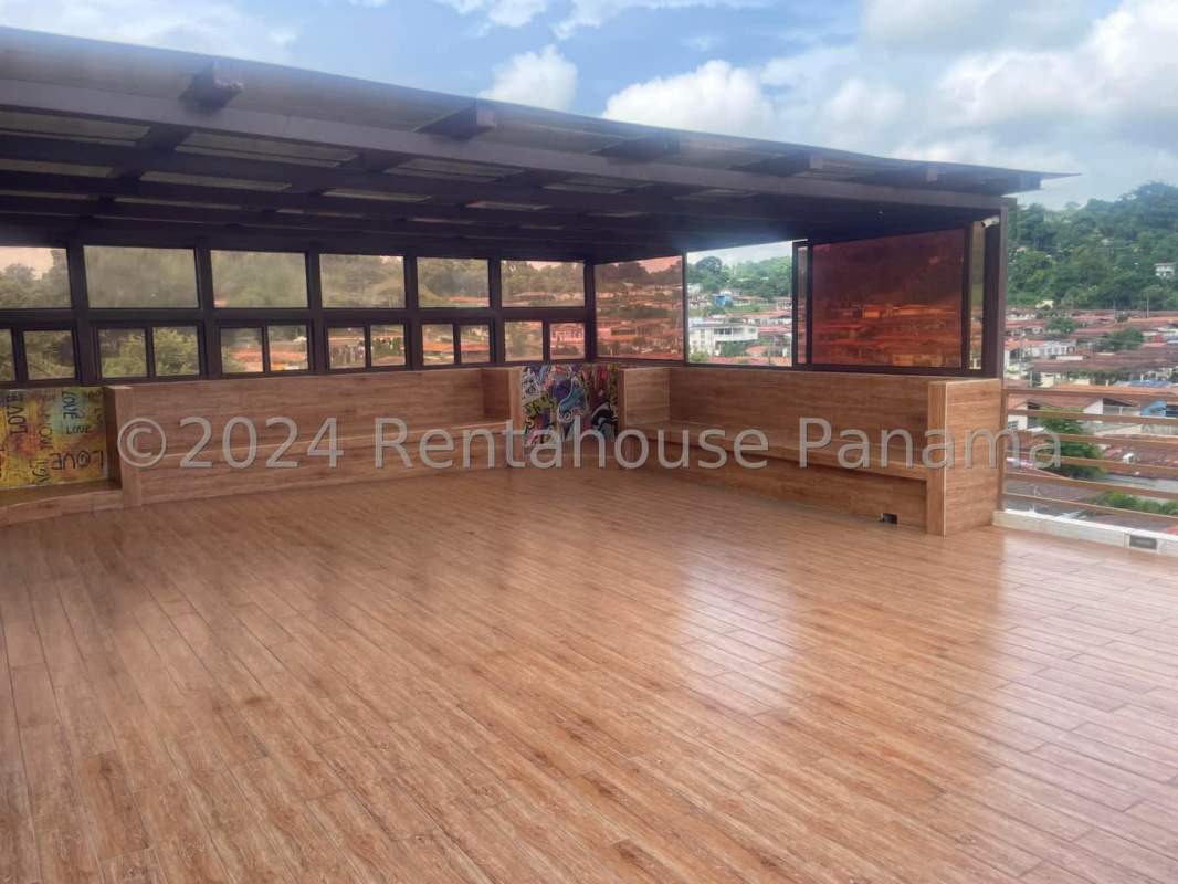 Contemporary granite kitchen with island and stainless hood in remodeled house Brisas del Golf Panama City