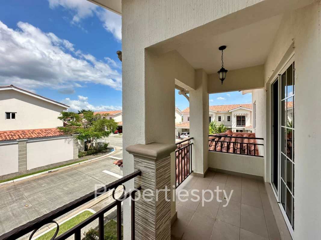 Covered balcony overlooking residential Versalles neighborhood with terracotta roofs Panama City