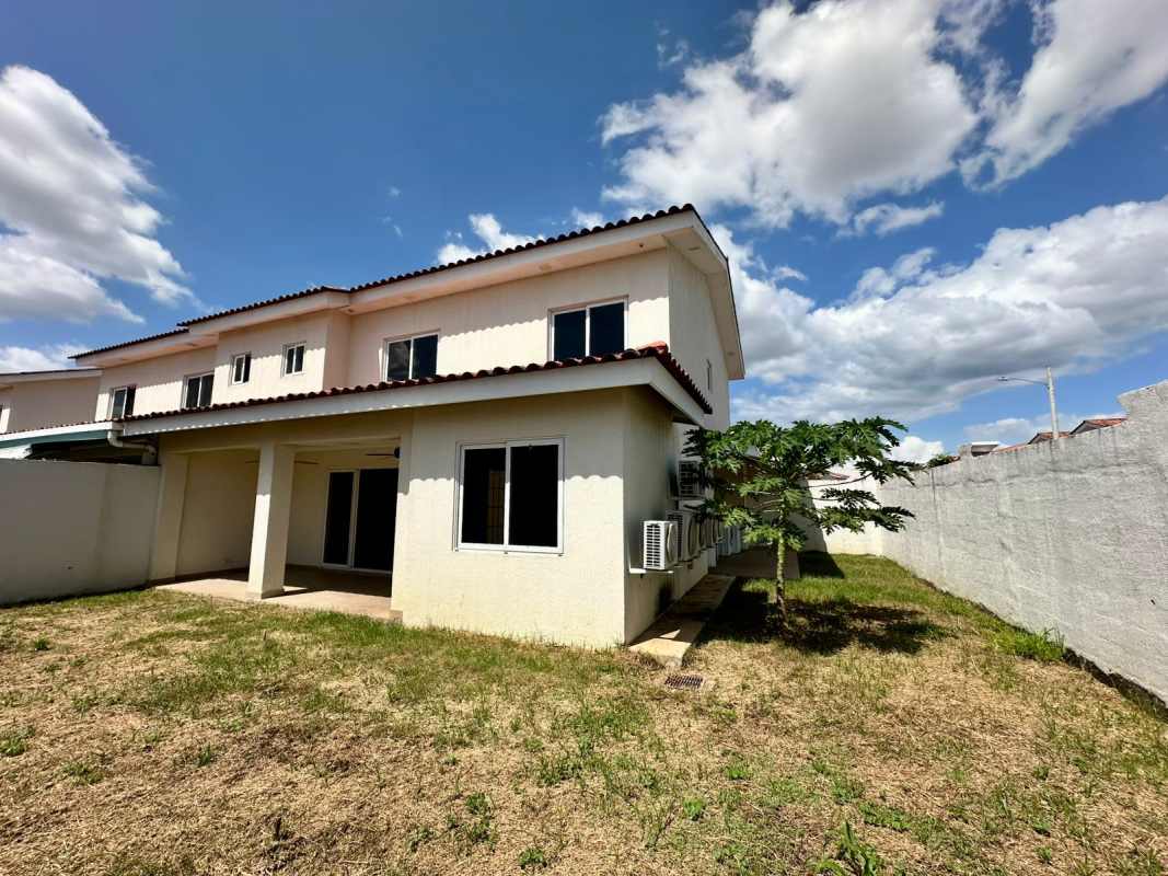 Exterior two-story duplex house with tiled roof and private backyard Versalles Panama City