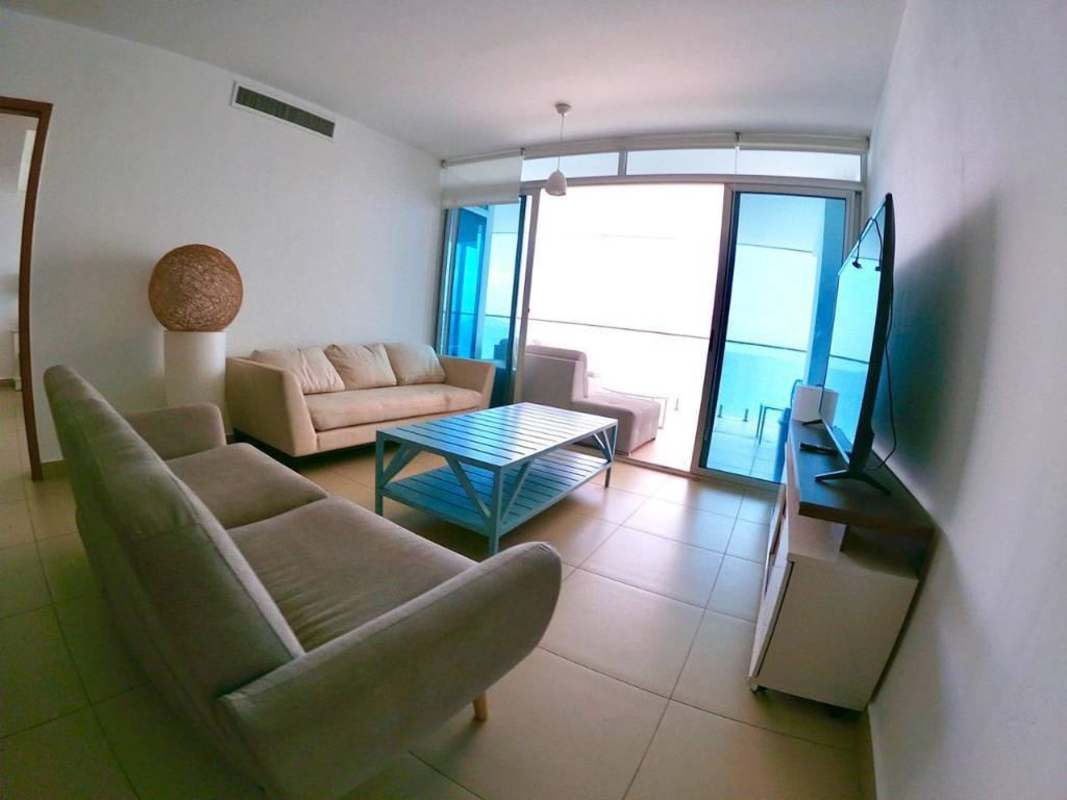 Open-concept kitchen with granite countertops stainless appliances in Isla Naos waterfront condo Panama