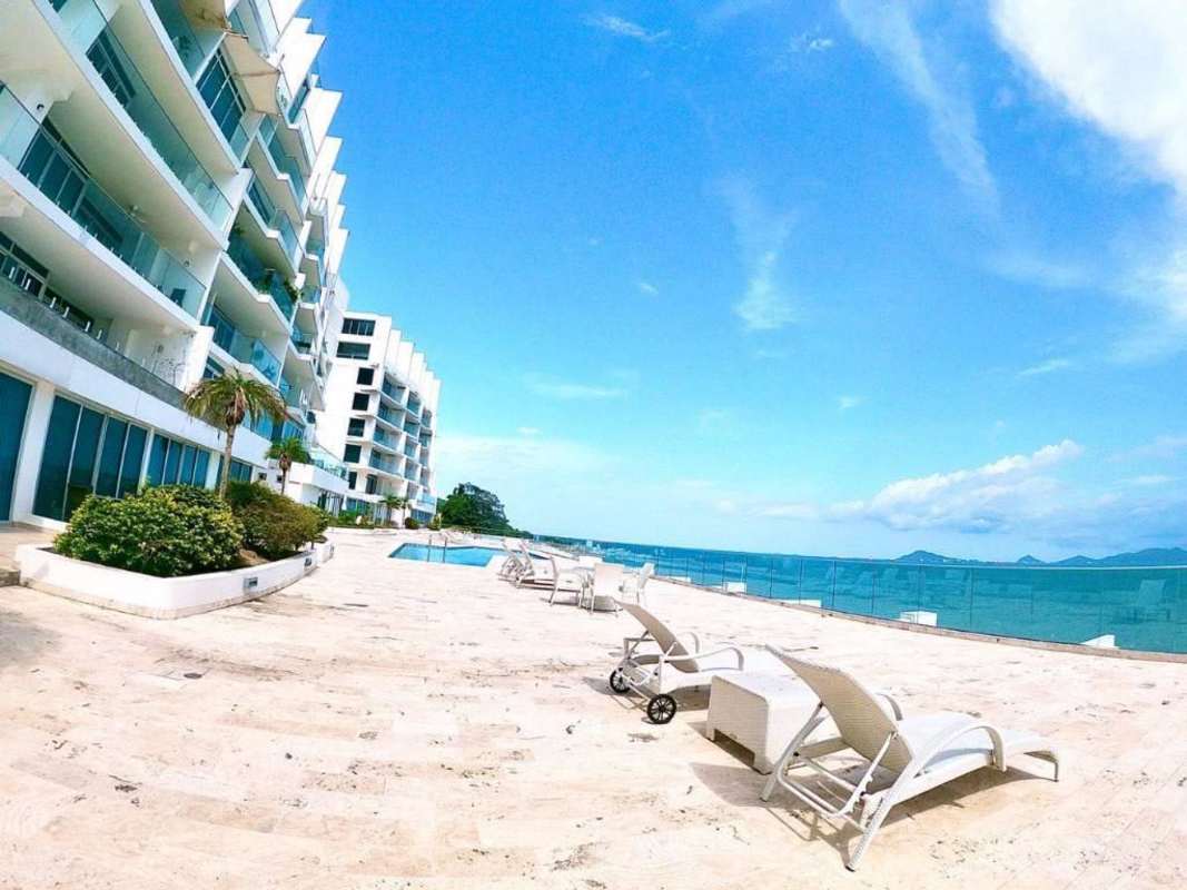 Bright furnished living room with sliding glass door balcony ocean views in Naos Harbor Island Panama