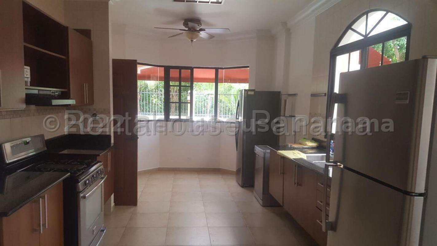 Mediterranean covered terrace with fans, garden views and lounge seating at Clayton luxury rental