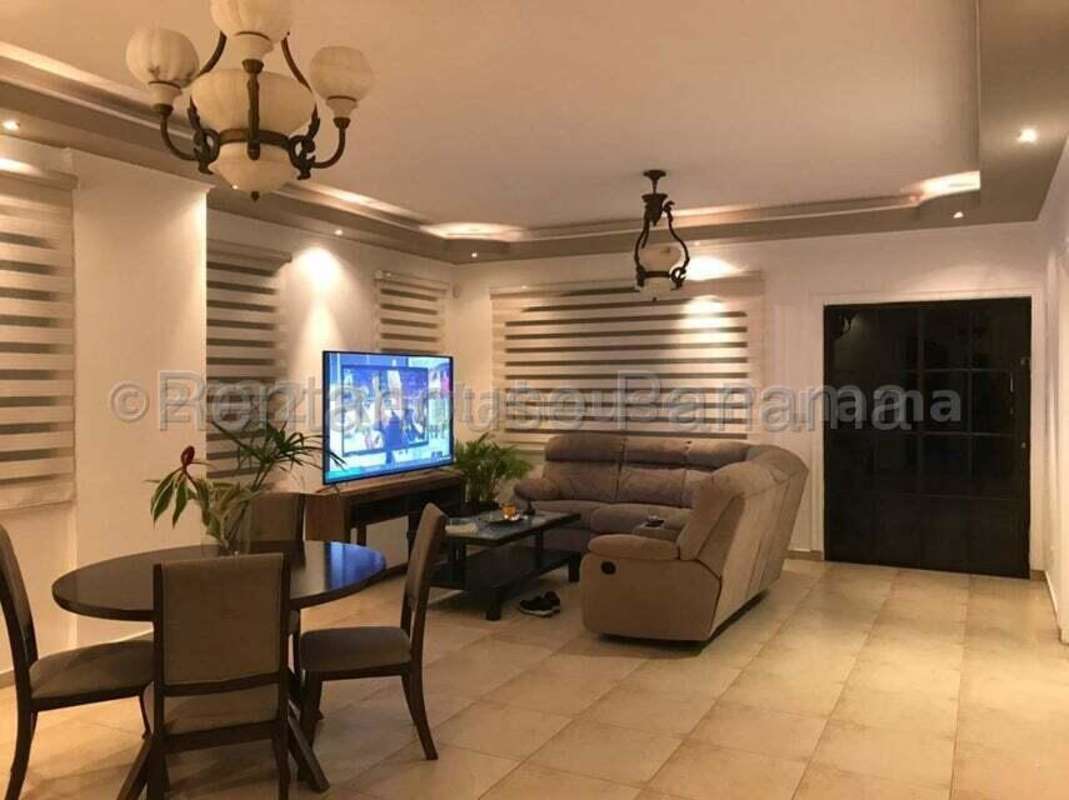 Modern bedroom with king bed, fan, large window overlooking garden in Clayton rental Panama