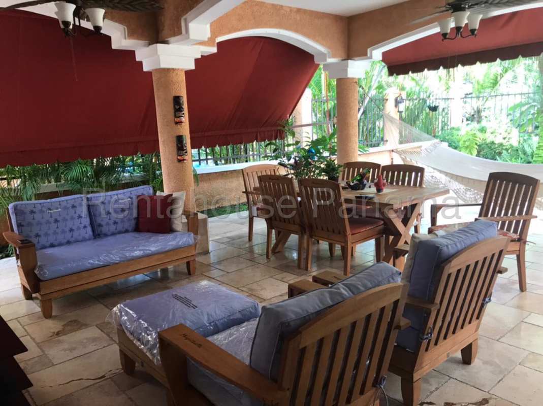 Bright living room with contemporary patchwork furniture and large window for rent in Clayton Panama