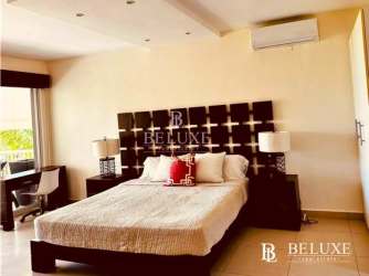 Master bedroom with oceanfront view and balcony at PH Balboa Bijao Panama