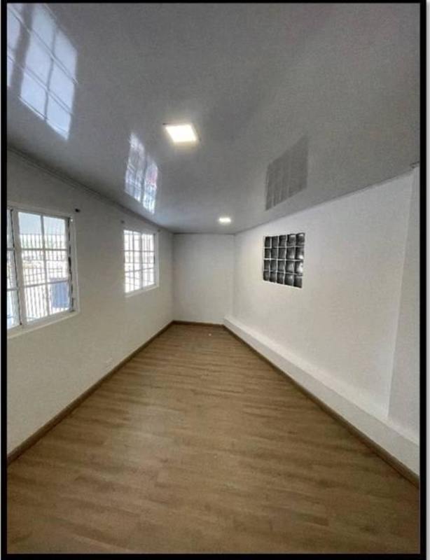 Bright multipurpose interior space with wood-look flooring, large windows in Cerro Viento Panama