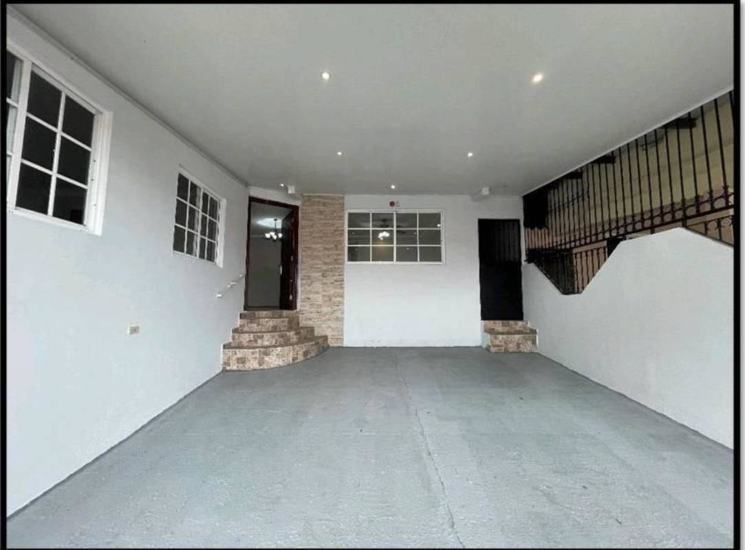 Indoor garage with tiled stairs, stone accent wall, recessed lights in Cerro Viento Panama