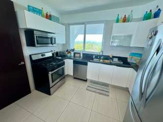 Modern kitchen with white cabinets granite countertops and appliances PH Barcovento Panama