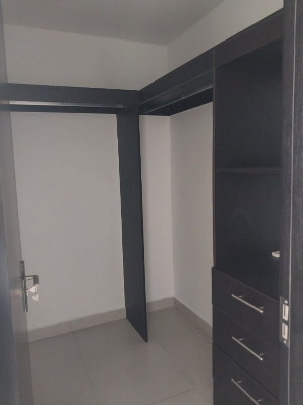 Guest bedroom in PH Tee One with bright windows and tile floors