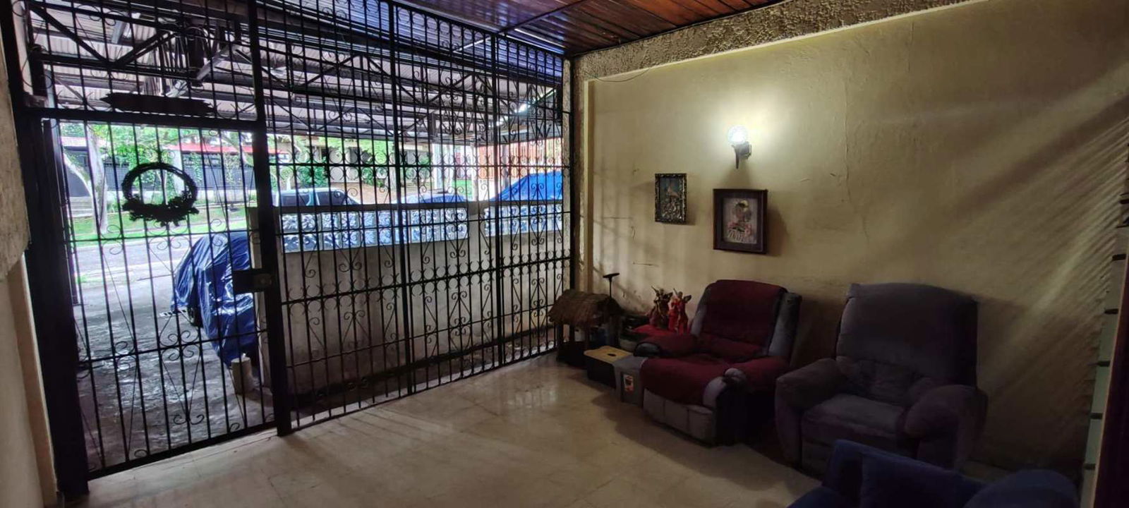 Kitchen with wooden cabinets, tiled counters and open shelf in Los Angeles Panama house