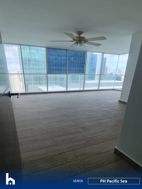 Spacious living area with floor-to-ceiling windows and balcony access in penthouse at PH Pacific Sea Panama