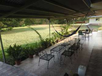 Rustic kitchen tiled floor, wooden ceiling and dining area in rural estate Coclé Panama