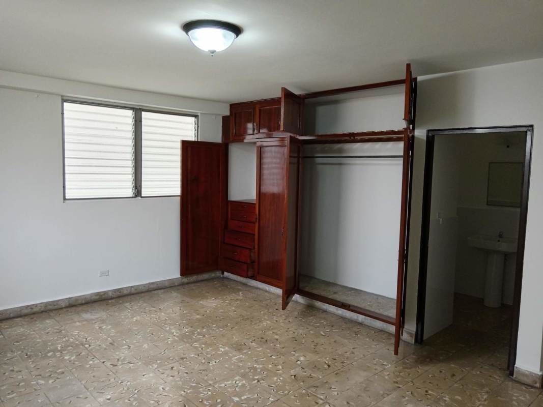 Bedroom with wooden closets and ensuite bathroom commercial house for sale San Miguelito Panama