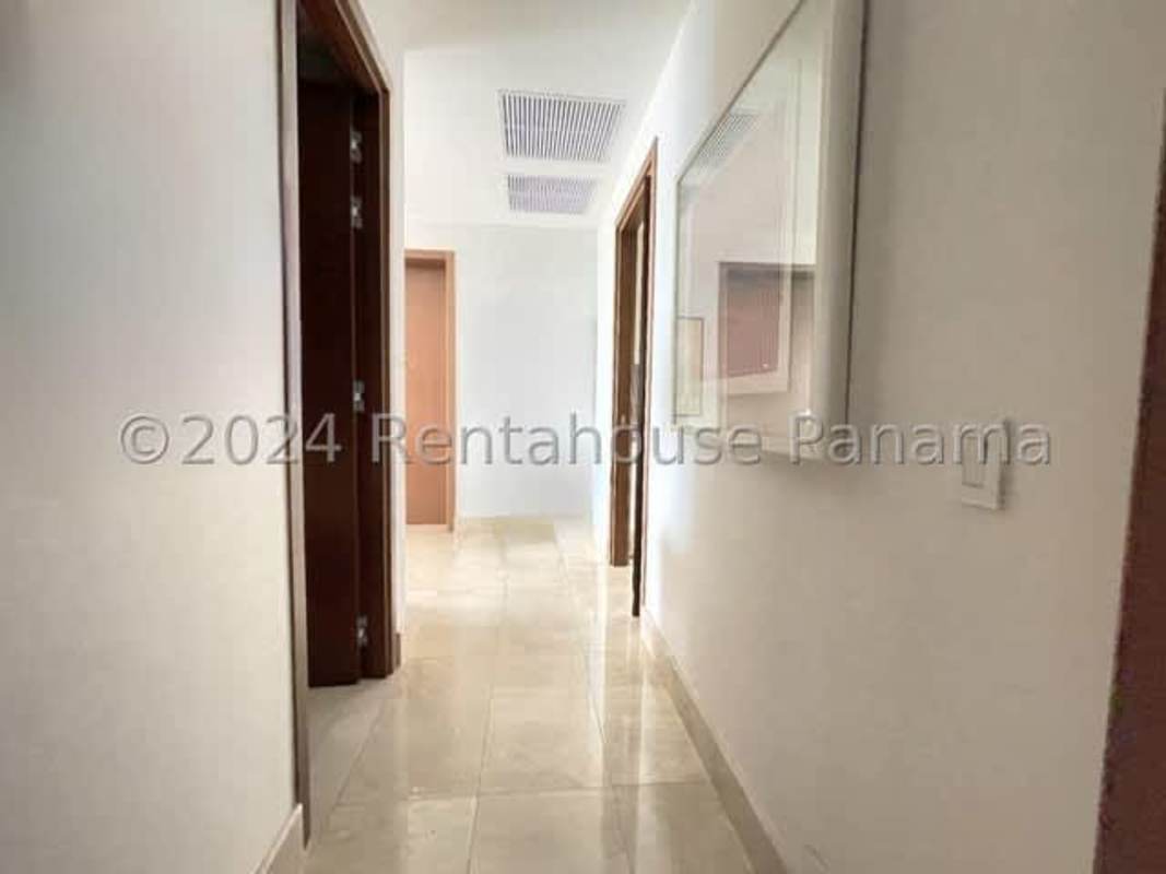 Bright corridor in PH Santa Maria condo with polished tile floor and recessed lighting