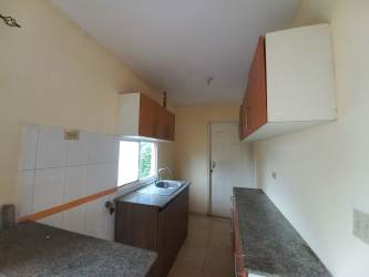 Simple kitchen with granite countertops and cabinetry in rental house Arboledas La Chorrera Panama