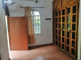 Bedroom with wooden wardrobe and garden view in Penonomé Panama house