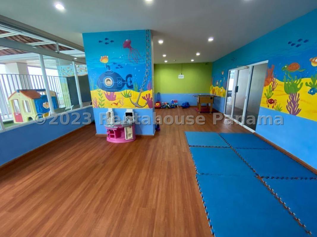 Colorful indoor children's playroom with murals and wood flooring at PH Oceanview Tower Punta Paitilla Panama