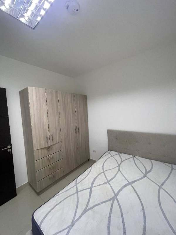 Dining area with glass table and living room in apartment Costa del Este Panama City