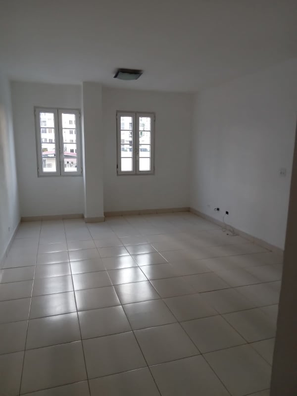 Compact bathroom with blue accent tiles, toilet and sink in PH Capri San Francisco Panama