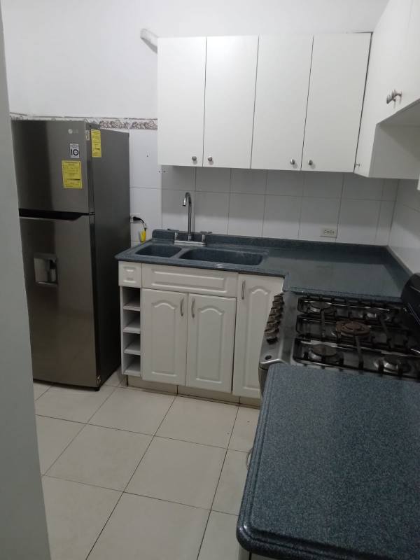 Half bathroom with sink, toilet, mirror, tiled walls in PH Capri San Francisco Panama