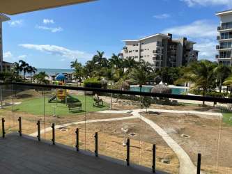Bright bedroom with sliding glass balcony door, natural light and wood style floors at Playa Caracol Punta Chame