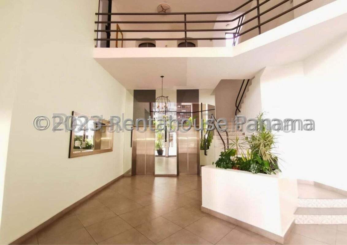 Modern secure entrance with glass doors, plants, and lobby inside PH Vizcaya Panama City