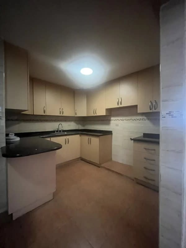 Bright bedroom or office with AC and security window grille in Panama City