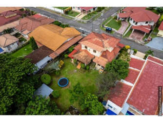 Aerial view two-story Mediterranean home with spacious backyard, trampoline, lush garden Villa Venice David Panama