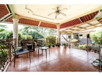 Spacious tiled covered terrace with ceiling fan, garden views perfect for outdoor living Villa Venice El Terronal David Panama
