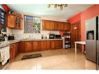 Traditional kitchen featuring wooden cabinetry appliances tile floors Villa Venice David Panama