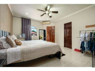 Master bedroom with tiled floor ceiling fan large window closet Villa Venice David Panama
