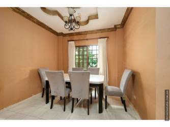 Elegant dining area with chandelier tray ceiling window natural light Villa Venice El Terronal David Panama