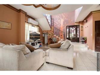 Spacious living room with sectional sofa TV staircase decorative features Villa Venice David Panama