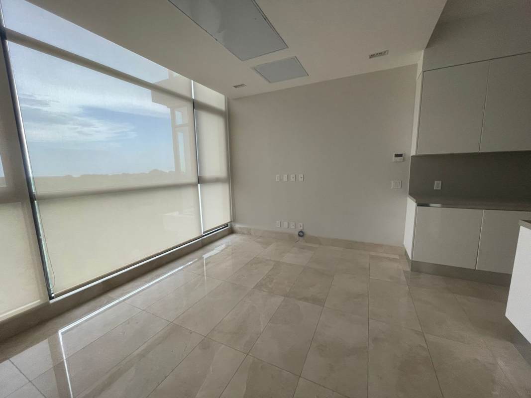 Expansive open-plan living dining room with floor-to-ceiling windows and marble flooring in PH Albatros Santa María