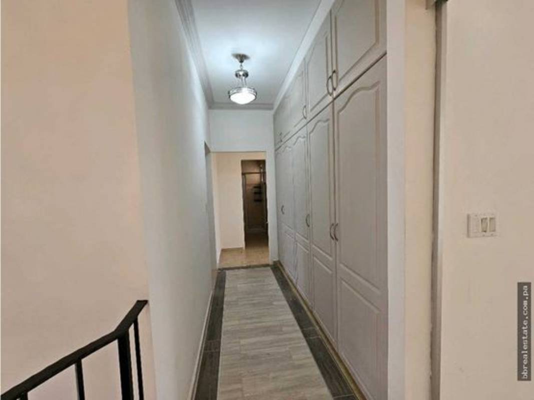 Large walk-in closet with built-in hanging and shelving in PH Palmeras del Este Panama City