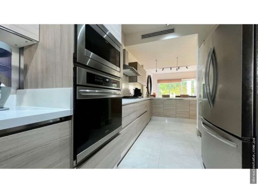 Contemporary dining room with natural light and patio views in Santa Maria Townhouse