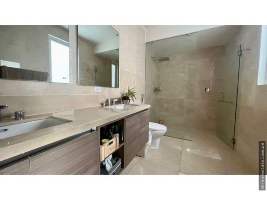 Living room with tiled floors and large glass doors in The Reserve townhome Panama