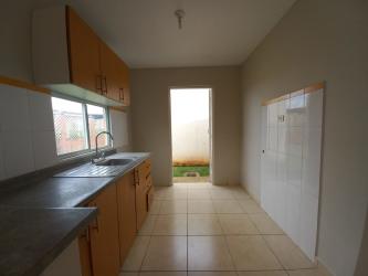 Simple kitchen with ceramic floor tiles and window in Los Almendros home for rent
