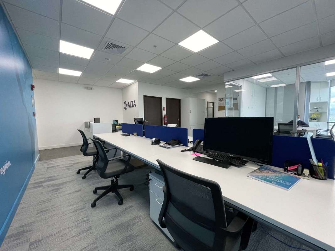 Glass-enclosed conference room with skyline views in corporate tower Costa del Este