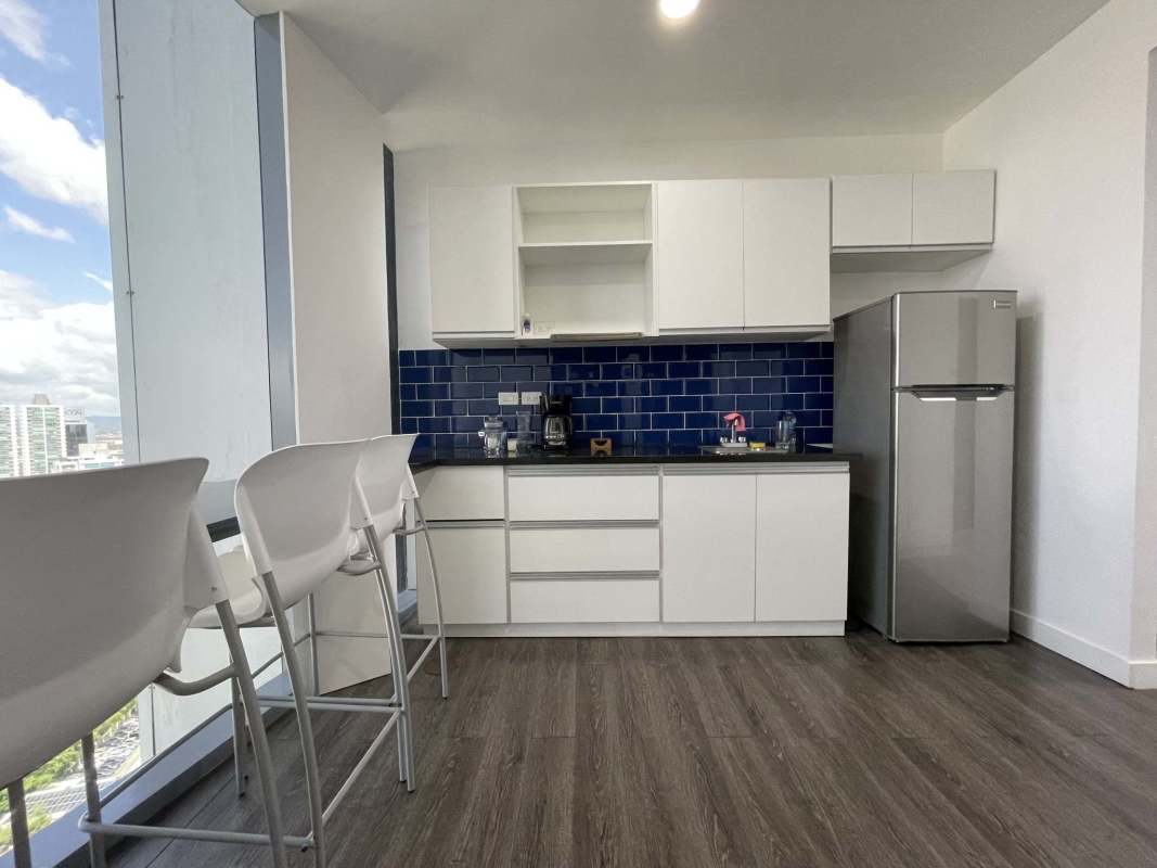 Compact kitchen space with large window and skyline view corporate office Panama