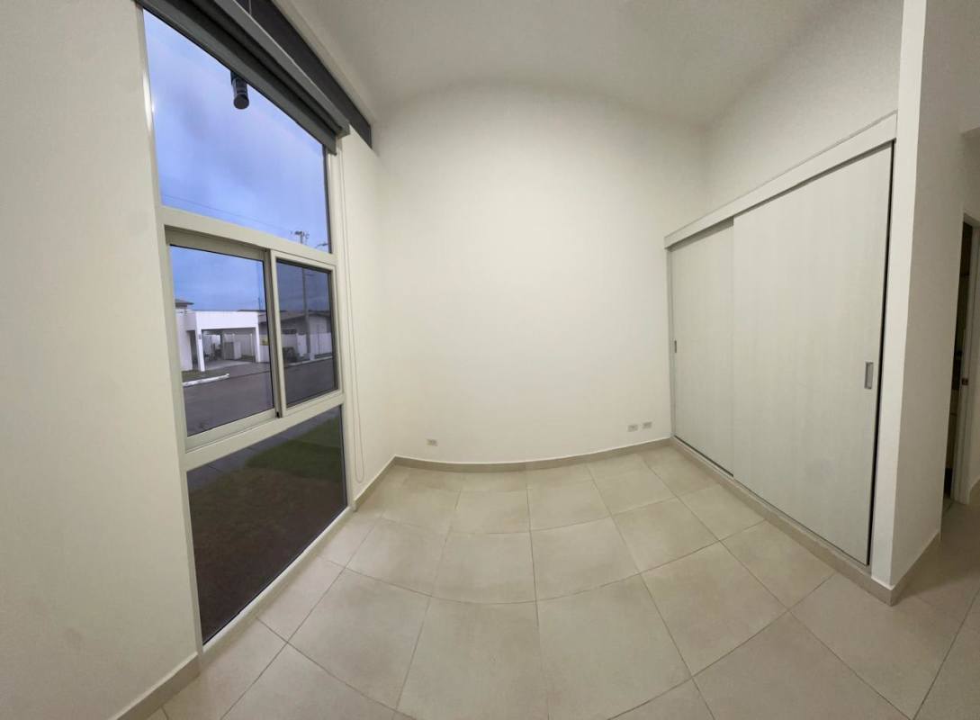 Private fenced backyard with lawn and white vinyl fence Villasur Residences Costa Sur Panama City