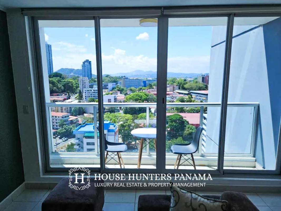 Bright living room with balcony access in apartment at PH Miró El Cangrejo Panama
