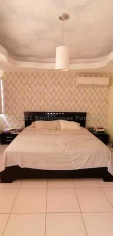 Bedroom featuring large window, tile floors, closet in Altos de Panama house