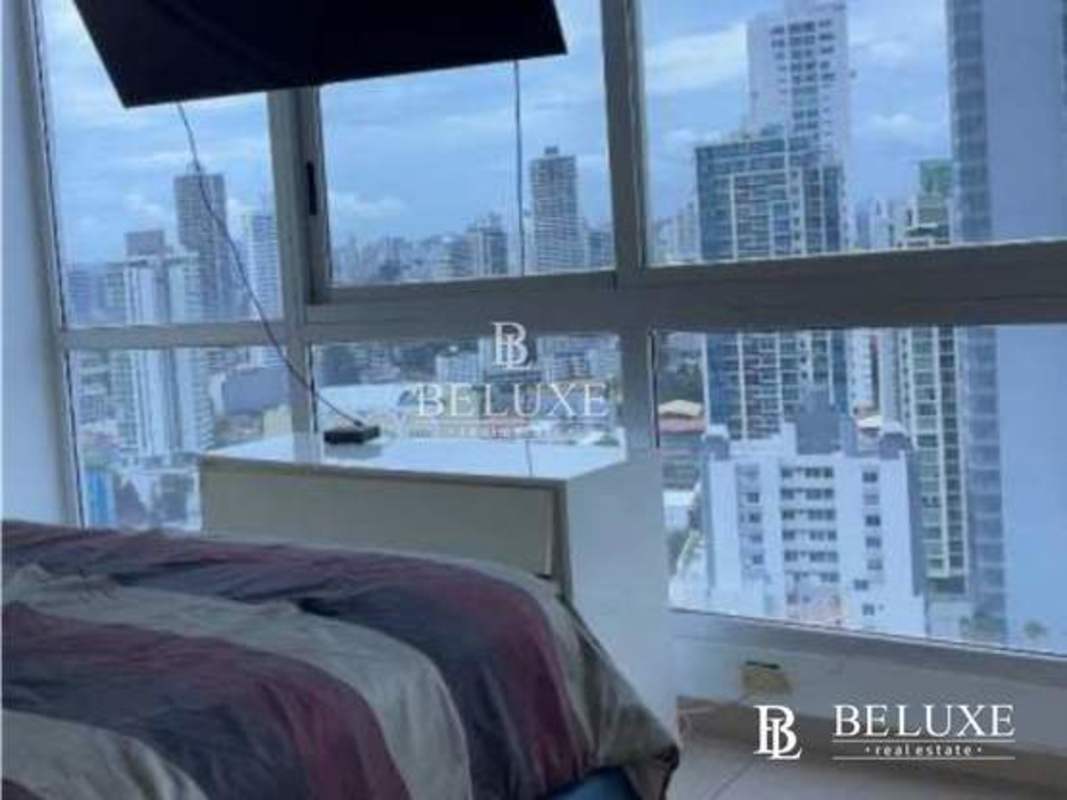 Secondary bedroom with floor to ceiling windows offering city skyline view in PH Vista Balboa Panama